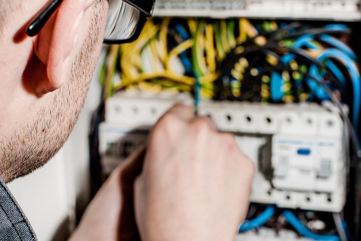 Elektrikár pri práci v elektrickom rozvádzači